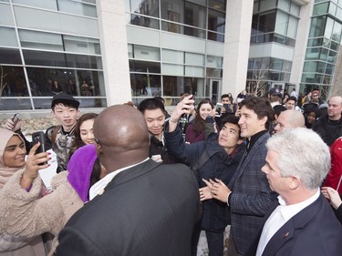 Prime Minister Justin Trudeau takes a selfie during his walking tour on the University of Regina campus in Regina.