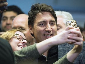 Prime Minister Justin Trudeau takes a selfie during his walking tour on the University of Regina campus in Regina.