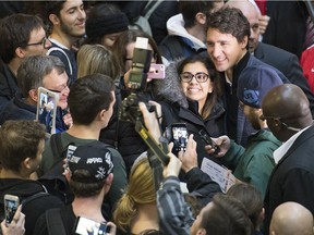 Prime Minister Justin Trudeau takes a selfie during his walking tour on the University of Regina campus in Regina.