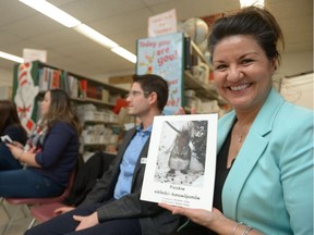 Sarah Longman, supervisor of aboriginal education at Regina Public Schools, holds a Cree copy of a recently translated "Buffalo Book" at Albert School.