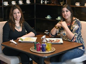 Ghizlane Erriha (left) and her sister Houda Erriha sit with crepes and tea at La Kasbah Du Maroc.