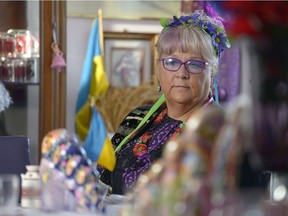 Barb Dedi looks at her dining room table, set with numerous Ukrainian cultural objects and symbols. Dedi will host a large meal in the evening to celebrate Ukrainian Christmas Eve.