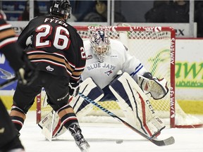 Regina Pats goalie Tyler Brown stops Andrew Fyten of the Calgary Hitmen during first-period WHL action at the Brandt Centre on Friday.