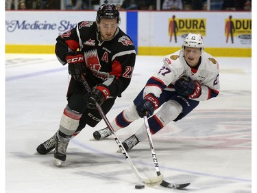 Moose Jaw Warriors forward Noah Gregor tries to pull away from Regina Pats forward Austin Wagner during WHL action at the Brandt Centre on Saturday.