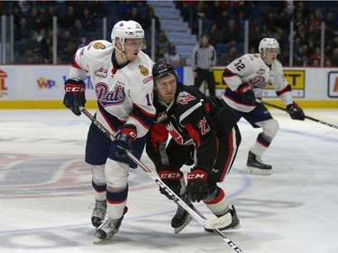 Regina Pats forward Braydon Buziak bumps into Moose Jaw Warriors forward Noah Gregor during WHL action on Saturday night at the Brandt Centre.