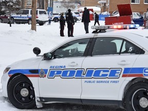 Members of the Regina Police Service attend to an alley behind the 3000 block of Parliament Avenue after reports of gun shots being fired in Regina.