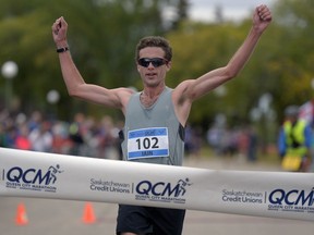 Iain Fyfe of Regina crosses the finish line to win the 2016 Queen City Marathon.
