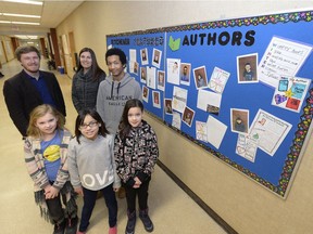 Students and teachers in front of the Author's Wall at Kitchener School. The wall encourages literacy and mentorship at the inner city school by showcasing the work of students. Teachers, Devon Floyd and Sharla Currie (back) and students (L-R) Trisha Hockley, Dallas, Devontae Redlick and Kaya Prettyshield.