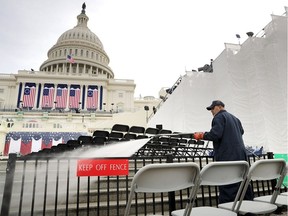 WASHINGTON, DC - JANUARY 19:  Architect of the Capitol Stone Mason Division employee Romel Lazo uses a power washer to clean the West Front of the U.S. Capitol one day before the inaguration of Donald Trump January 19, 2017 in Washington, DC. Hundreds of thousands of people are expected to come to the National Mall to witness Trump being sworn in as the 45th president of the United States.