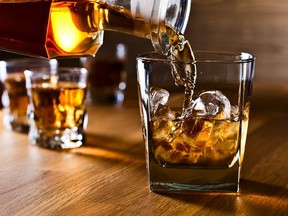 whiskey and natural ice on old wooden table. Credit: Getty Images