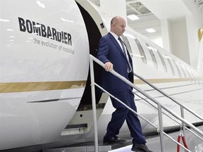 Bombardier CEO Alain Bellemare steps off of a model of a Global 7000 jet before making a press conference in Montreal on Tuesday, February 7, 2017. THE CANADIAN PRESS/Paul Chiasson