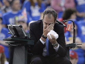 Umpire Arnaud Gabas of France holds his face after being hit by a ball during first round Davis Cup tennis action between Canada&#039;s Denis Shapovalov and Great Britain&#039;s Kyle Edmund, Sunday, Feb. 5, 2017 in Ottawa. Gabas has had surgery on a fractured bone under his left eye after being hit by a ball struck by Shapovalov during a Davis Cup match. THE CANADIAN PRESS/Justin Tang
