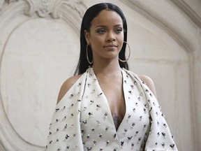 FILE - In this Sept. 30, 2016 file photo, singer Rihanna poses for photographers as she arrives to Christian Dior&#039;s Spring-Summer 2017 ready-to-wear fashion collection presented in Paris. Harvard University will present the singer with the Peter J. Gomes Humanitarian Award on Tuesday, Feb. 28, 2017, during a ceremony on campus in Cambridge, Mass., (AP Photo/Thibault Camus, File)