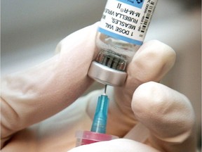 A nurse draws a dose of mumps, measles, and rubella vaccine in Wichita, Kan., April 24, 2006.