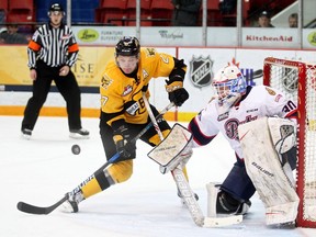 The Brandon Wheat Kings' Reid Duke tries to deflect the puck in front of Regina Pats goaltender Jordan Hollett on Friday night.