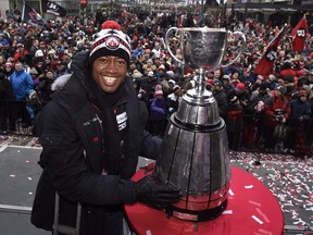 Ottawa Redblacks quarterback Henry Burris celebrates the team's 2016 Grey Cup victory at a rally in the nation's capital.