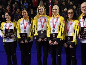 Left to right, Manitoba skip Michelle Englot, third Kate Cameron, second Leslie Wilson, lead Raunora Westcott, alternate Krysten Karwacki and coach Ron Westcott are presented with silver medals at the Scoties Tournament of Hearts on Sunday in St. Catharines, Ont.