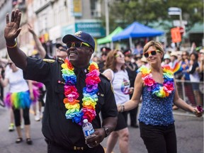 Toronto's police chief says he understands the LGBTQ community is divided and decided his force wouldn't participate in the city's parade to enable those differences to be addressed. Toronto police chief Mark Saunders marches during the annual Pride Parade in Toronto, in a July 3, 2016, file photo.