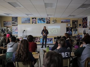 Gary Edward speaking at a school during a presentation on Signs of Your Identity a photobook project on residential school survivors living in Regina