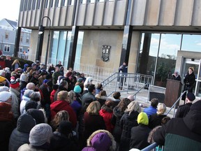 People gathered at a solidarity rally at the city hall in Sarnia, Ont. on Thursday sing 'O Canada' while denouncing the recent Quebec mosque massacre that left six men at prayer shot dead.