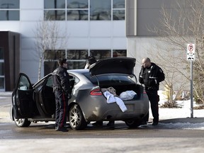 Regina Police Service members search a car in the parking lot of Evraz Place in Regina. Police responded to a gun call at 12:41 p.m. Tuesday at the 2600 block of Dewdney Avenue and this vehicle was suspected to be involved in the call.