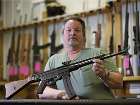 Francis Besplug, owner of Pawn King, holds a GSG Schmeisser stg-44 .22 calibre long rifle at his store in Regina on Feb. 15, prior to the Sunday theft.