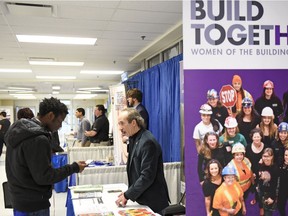Fidel Djoda, left, speaks with Gunnar Passmore, of Saskatchewan Building Trades, during the annual Saskatchewan Polytechnic Job Fair in Regina on Tuesday, Feb. 2, 2017.