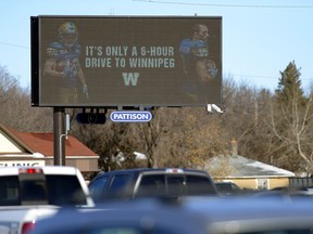 Former Regina Roughriders Ryan Smith, left, and Weston Dressler, right, appear on a digital billboard at Dewdney Ave. and Lewvan Drive.