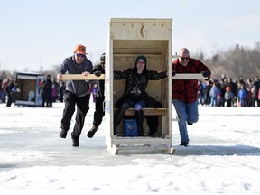 Teams compete in the Outhouse Races during Waskimo held on Wascana Lake in Regina.