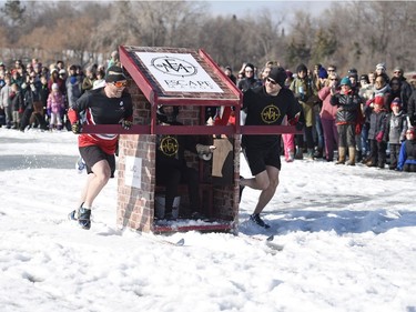 Teams compete in the Outhouse Races during Waskimo held on Wascana Lake in Regina.