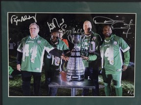 This photo, autographed by Saskatchewan Roughriders legends Roger Aldag, George Reed, Gene Makowsky and Darian Durant, will be available at the Raise-a-Reader sports memorabilia sale on Sunday at the Conexus Arts Centre.
