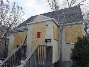 A house sits boarded-up from a house fire at 1729 Connaught Street.