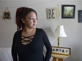 Alison Moneybird-Morgan looks out the window of her home. Her brother, Jesse Moneybird, was shot last night in the home.