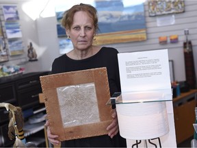 McLeod, owner of Rumours Airport Gift Shop, holds up a piece of  late artist Angelique Merasty rare birch bark biting.