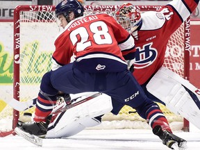 Lethbridge Hurricanes goalie Stuart Skinner makes a pad save in front of ex-Regina Pats defenceman Brady Pouteau, helping the visitors prevail 4-1 in WHL action at the Brandt Centre on Tuesday.