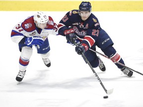 Conner McDonald of the Edmonton Oil Kings tries to knock Regina Pats centre Sam Steel off the puck during Saturday's WHL game at the Brandt Centre.