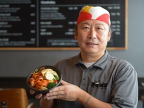 Executive chef and owner Chris Park holds a shrimp sae-woo bowl at Bomb.