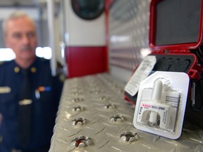 Regina Fire and Protective Service fire chief Ernie Polsom looks on at a nasal spray used in drug overdose situations. The inhaler will compliment other life-saving devices found on fire trucks.