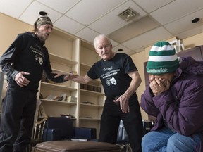 Ed Stamm, left, Bob Hughes, centre, and Linda Cunningham, right, members of the Reel Anti-Suppressants Popular Theatre Group, perform a skit during a rehearsal at the Regina office of the Canadian Mental Health Association.