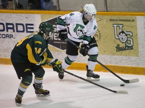 University of Saskatchewan Huskies defender Brooke Patron, right, fights for the puck against University of Regina Cougars defender Nikki Watters-Matthes in Friday's opener of a Canada West women's hockey quarter-final. The U of S won 4-3 on Friday and ended the series on Saturday with a 2-1 victory.