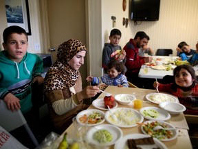 Syrian refugee families gather in a hotel to eat ethnic food during their first weeks in Calgary on Tuesday, February 2, 2016.