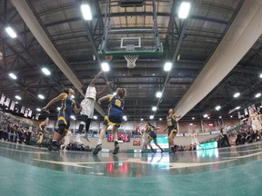 The University of Regina Cougars, in white, face the Trinity Western Spartans in Canada West women's basketball playoff action Thursday at the Centre for Kinesiology, Health and Sport.