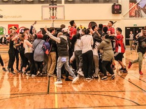 The Winnipeg Sisler Spartans celebrate a victory in the senior boys final at the 2017 Luther Invitational Tournament.