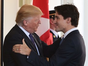 US President Donald Trump (L) greets Canada's Prime Minister Justin Trudeau upon arrival outside of the West Wing of the White House on February 13, 2017 in Washington, DC.