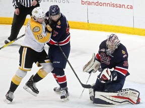 Nolan Patrick of the Brandon Wheat Kings tangles with Liam Schioler of the Regina Pats as netminder Tyler Brown tries to get a handle on the puck during WHL action at Westman Place on Sunday. (Tim Smith/The Brandon Sun)