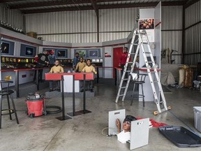 In this Saturday, March 25, 2017 photo, Steve Greenthal, left, and Chris Liebl work to set up their Star Trek wax figures in a hangar at the Fullerton Airport before donating them to the Hollywood Science Fiction Museum, in Fullerton, Calif. The figures are being restored for a five-year tour to raise money to get the museum a permanent home. (Nick Agro /The Orange County Register via AP)