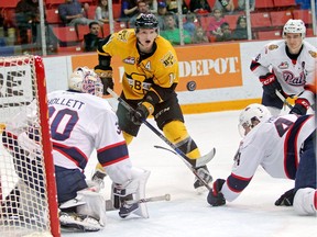Ty Lewis of the Brandon Wheat Kings eyes the loose puck in front of Regina Pats goalie Jordan Hollett during WHL action at Westman Place on Saturday. (Tim Smith/The Brandon Sun)