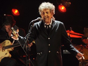 FILE - In this Jan. 12, 2012, file photo, Bob Dylan performs in Los Angeles. The city of Hibbing, Minn., has few things honoring its most famous son and Nobel laureate, Bob Dylan, and some residents think the city should do more. The singer-songwriter will be awarded the Nobel Prize in literature Saturday. Minnesota Public Radio News reports that Gov. Mark Dayton has proclaimed Saturday Nov. 11, 2016 as Bob Dylan Day in Minnesota.