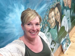 Bonny MacNab is shown in front of a portion of the mural she is painting for the new Mosaic Stadium. PHOTO COURTESY OF BONNY MACNAB
