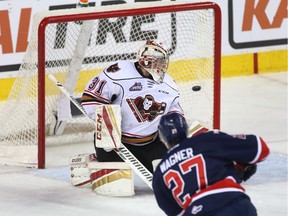 Regina Pats forward Austin Wagner scores his first of two goals against Calgary Hitmen goalie Cody Porter on Thursday. Wagner helped Regina win 5-1 and sweep a first-round WHL playoff series. The victory also gave Regina its first 12-game winning streak since 1982.